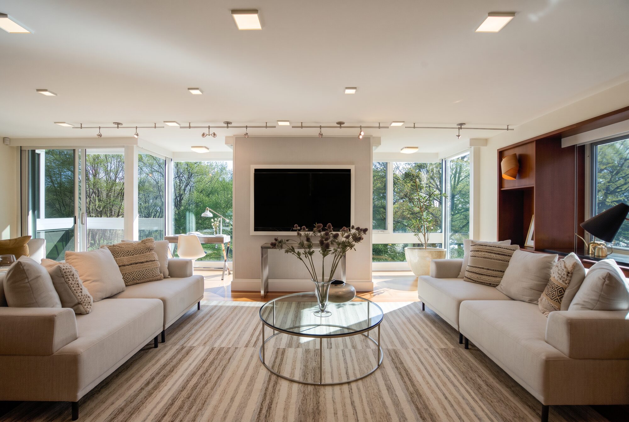 long living room with floor-to-ceiling glass — delivered through the Arboro pipeline